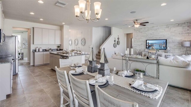 16025 7th Ave E, Bradenton, FL 34212 - dining space featuring a ceiling fan, recessed lighting, stairs, a chandelier, and light tile patterned floors