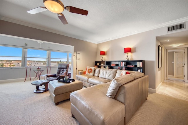 carpeted living room featuring a textured ceiling, ceiling fan, and crown molding