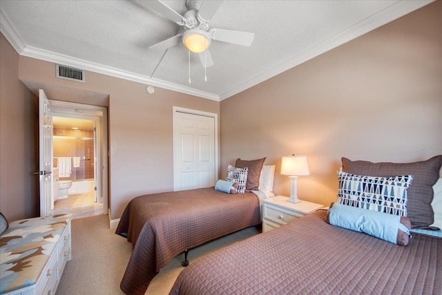 bedroom with ensuite bath, ceiling fan, crown molding, light carpet, and a closet