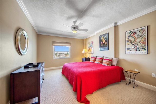 carpeted bedroom with a textured ceiling, ceiling fan, and crown molding