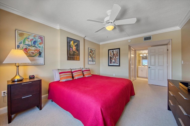 carpeted bedroom with a textured ceiling, ceiling fan, crown molding, and ensuite bathroom