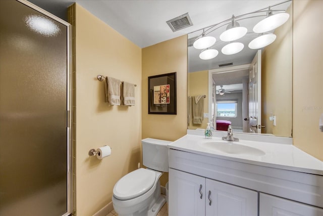 bathroom with vanity, a shower with door, tile patterned flooring, ceiling fan, and toilet