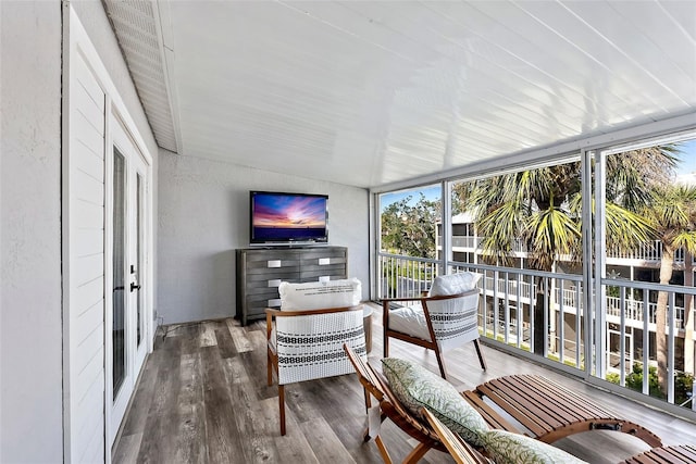 sunroom / solarium featuring lofted ceiling