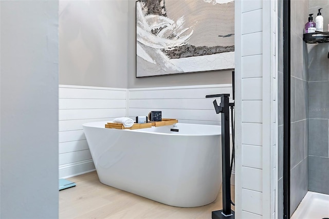 bathroom with separate shower and tub and wood-type flooring