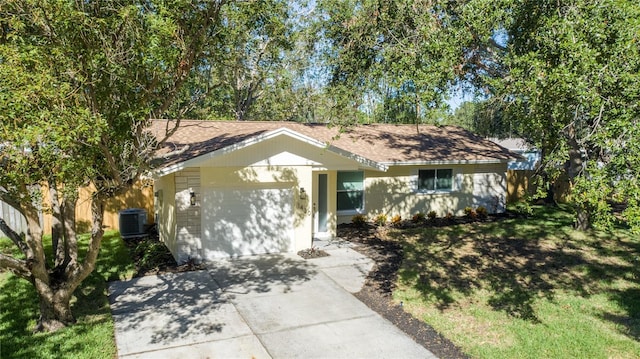 single story home with central air condition unit and a garage