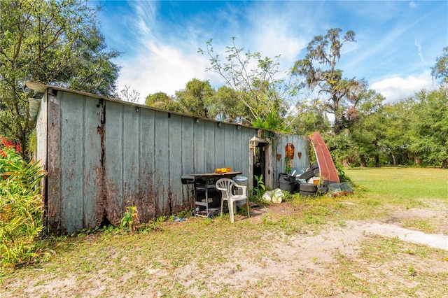 view of outbuilding featuring a yard