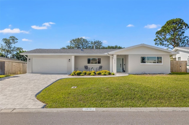 single story home featuring a front yard and a garage