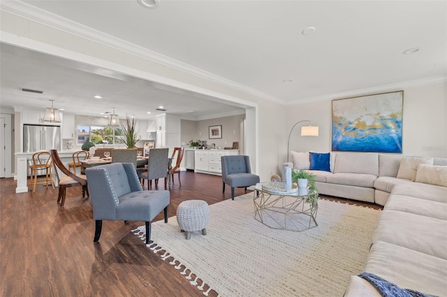 living room featuring dark wood-type flooring and ornamental molding