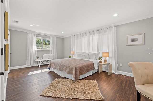 bedroom featuring crown molding and dark wood-type flooring