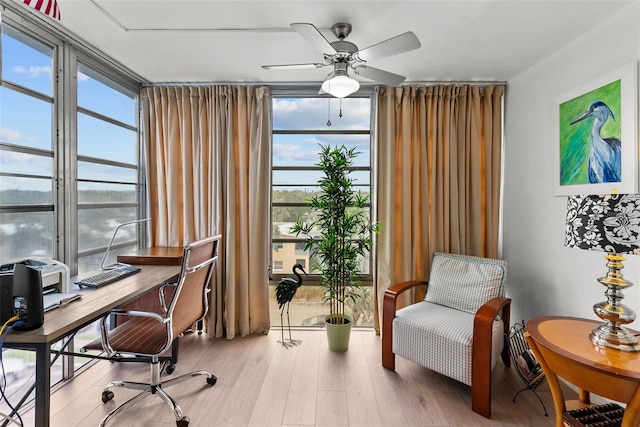 home office featuring wood-type flooring, plenty of natural light, and ceiling fan