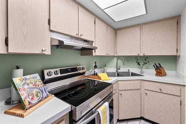 kitchen featuring electric stove, sink, and light brown cabinets