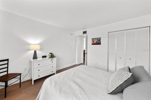 bedroom featuring dark hardwood / wood-style flooring and a closet