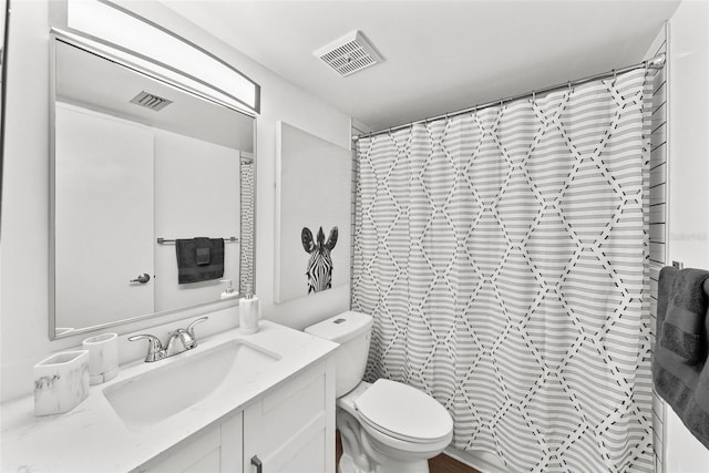 bathroom with vanity, a shower with shower curtain, and toilet