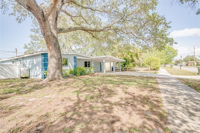 ranch-style home featuring a carport