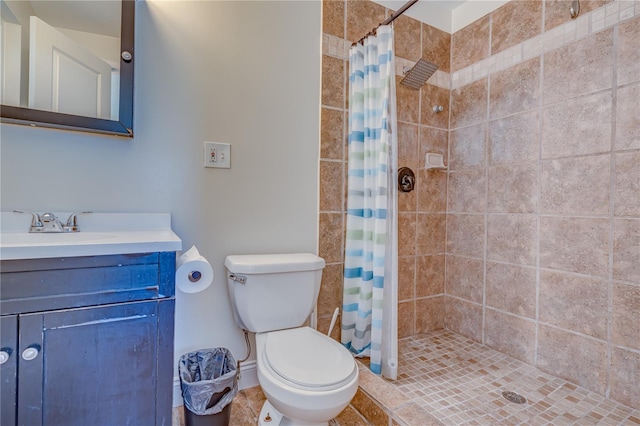 bathroom featuring tile patterned floors, vanity, toilet, and walk in shower