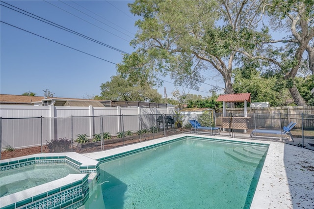 view of swimming pool with an in ground hot tub