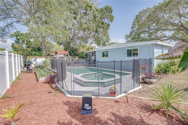 view of pool with an in ground hot tub