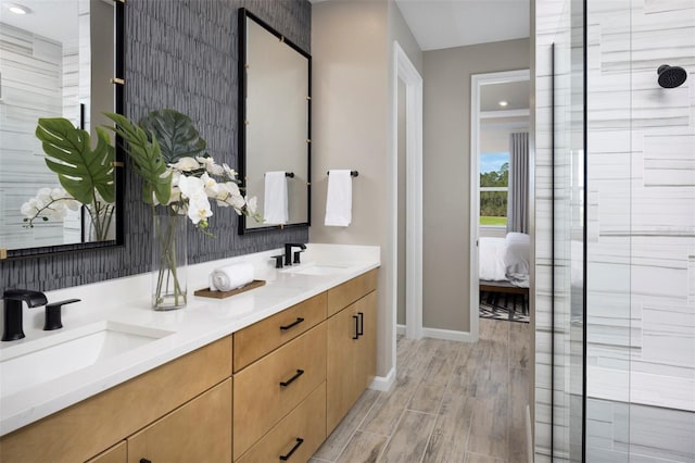 bathroom featuring hardwood / wood-style floors, vanity, and walk in shower