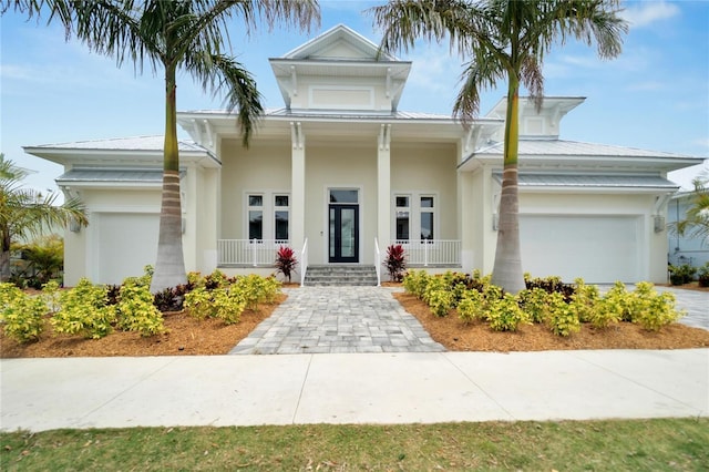 view of front of home with covered porch and a garage