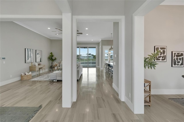 5713 Tybee Island Dr, Apollo Beach, FL 33572 - corridor featuring crown molding, baseboards, recessed lighting, and light wood-type flooring