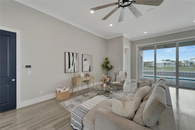 living room featuring light hardwood / wood-style flooring, ceiling fan, and ornamental molding