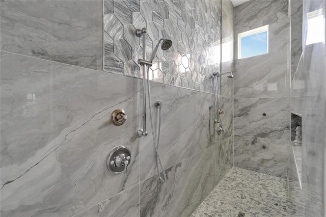 bathroom with a tile shower