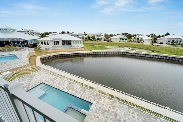 view of pool with a patio area and a water view