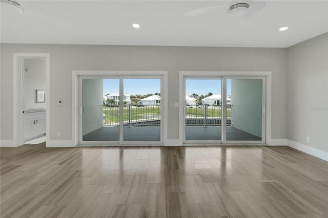 empty room featuring light wood-type flooring and ceiling fan