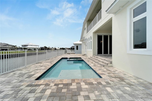 view of swimming pool with a water view and a patio