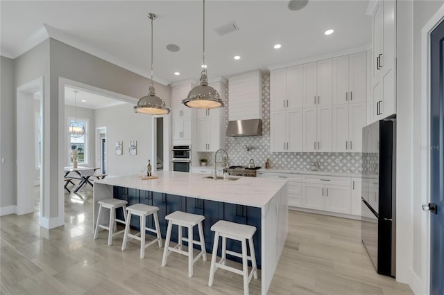 5713 Tybee Island Dr, Apollo Beach, FL 33572 - kitchen with freestanding refrigerator, a sink, double oven, tasteful backsplash, and white cabinetry