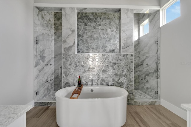 5713 Tybee Island Dr, Apollo Beach, FL 33572 - bathroom featuring a freestanding bath, a shower stall, tile walls, and wood tiled floors