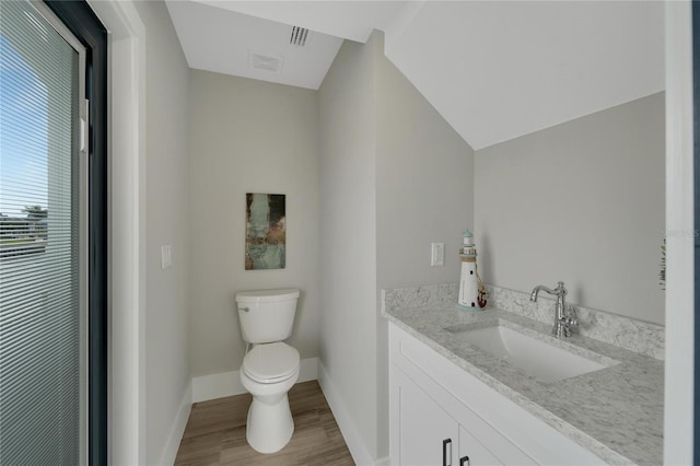 5713 Tybee Island Dr, Apollo Beach, FL 33572 - bathroom with toilet, wood finished floors, vanity, and baseboards