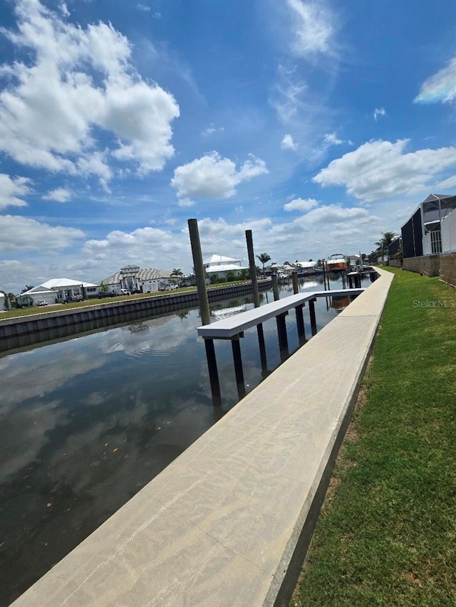 5713 Tybee Island Dr, Apollo Beach, FL 33572 - dock with a water view and a lawn