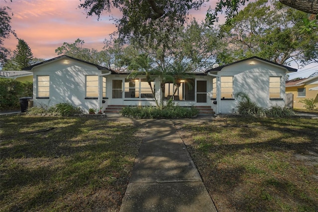 ranch-style home featuring a yard