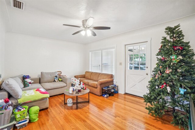 living room featuring hardwood / wood-style floors and ceiling fan