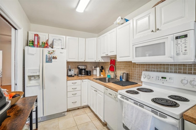 kitchen featuring butcher block countertops, white cabinets, white appliances, and sink