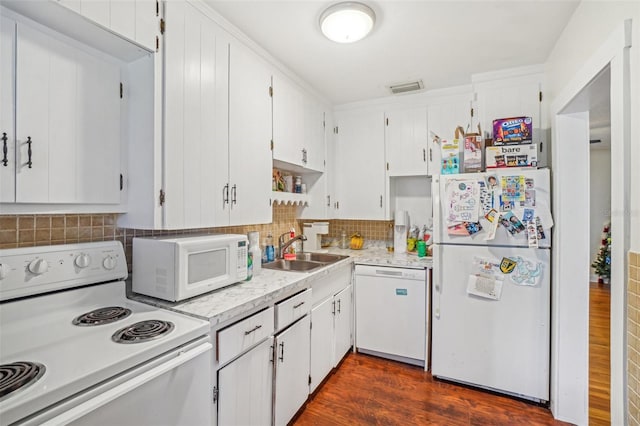 kitchen with white cabinets, dark hardwood / wood-style flooring, white appliances, and backsplash