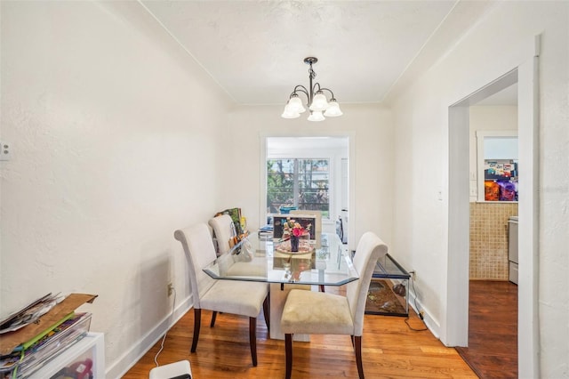 dining area featuring a chandelier and hardwood / wood-style flooring