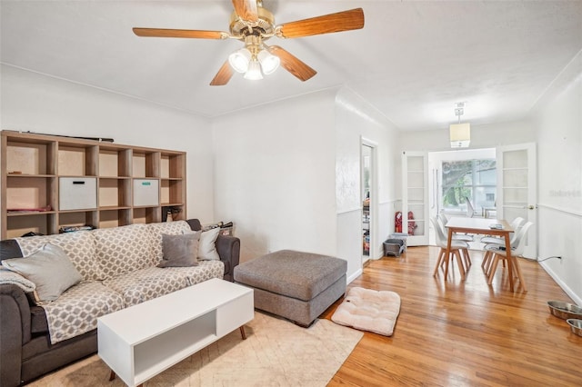 living room with ceiling fan and light wood-type flooring