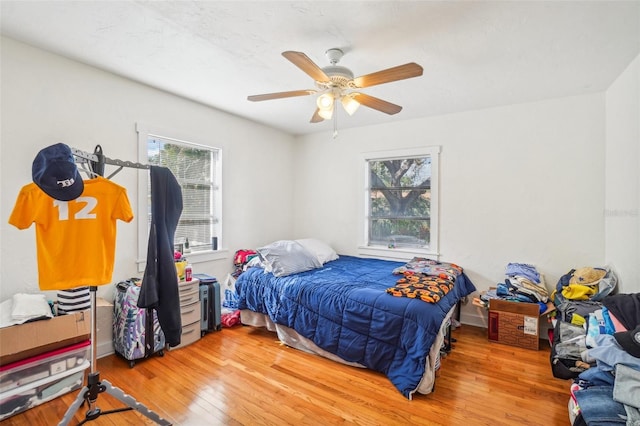 bedroom with ceiling fan and hardwood / wood-style flooring