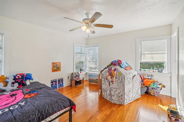 bedroom featuring hardwood / wood-style floors and ceiling fan