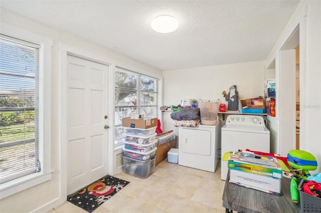 washroom with a textured ceiling and washing machine and clothes dryer