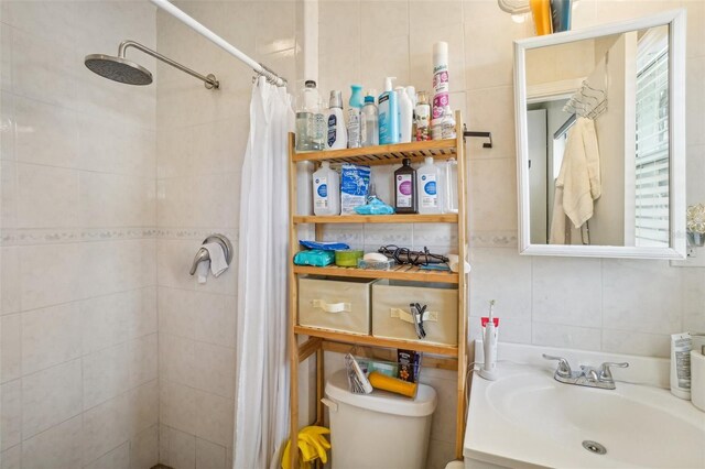 bathroom with a shower with curtain, toilet, tile walls, and vanity