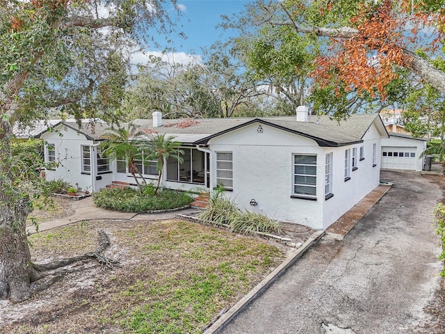 view of front of property featuring an outbuilding and a garage