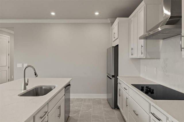 kitchen with wall chimney exhaust hood, stainless steel appliances, sink, and white cabinets