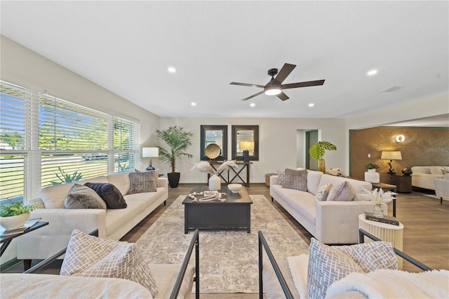 living room with ceiling fan and light hardwood / wood-style floors