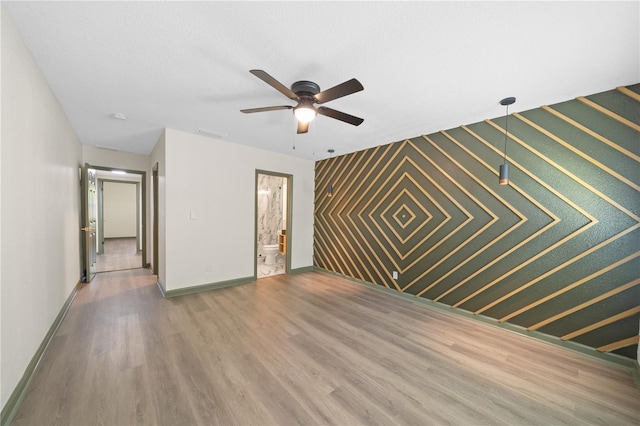 spare room with hardwood / wood-style flooring and ceiling fan