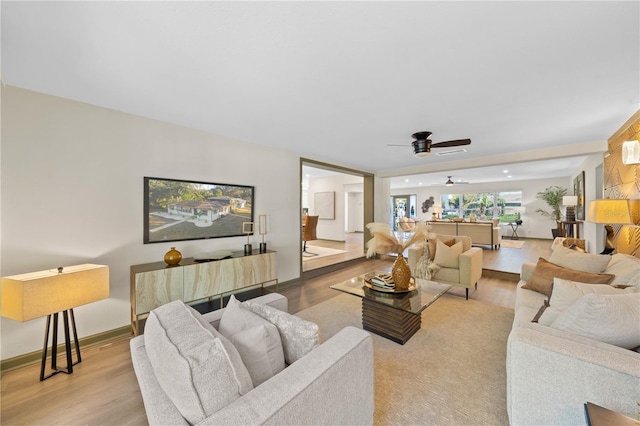 living room with ceiling fan and light hardwood / wood-style floors