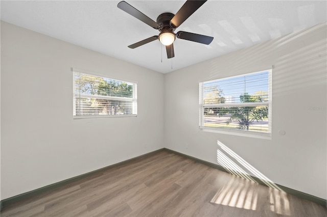 unfurnished room with ceiling fan and hardwood / wood-style floors