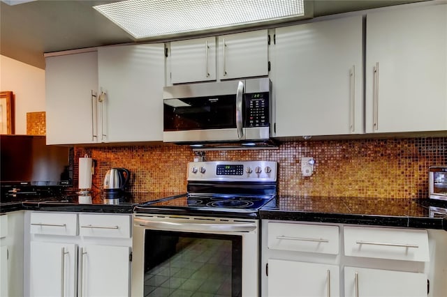 kitchen with white cabinets, appliances with stainless steel finishes, and decorative backsplash